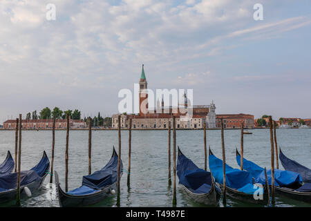 Panoramic view of Laguna Veneta of Venice city with gondolas and away San Giorgio Maggiore Island. Landscape of summer morning day and dramatic blue s Stock Photo