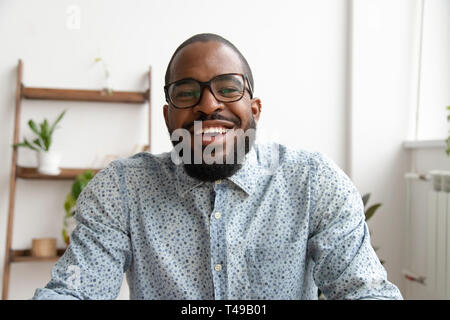Happy african businessman looking at webcam making conference video call Stock Photo
