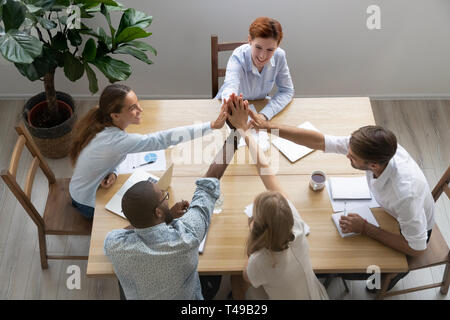 Happy united diverse business team people give high five together Stock Photo