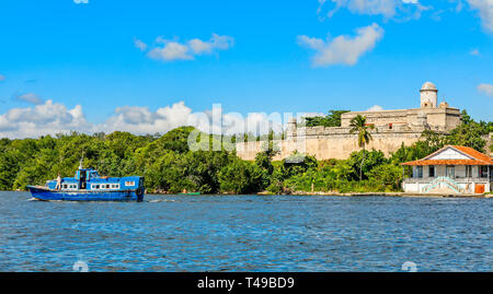 Jagua castle fortified walls with trees and fishing boats in the foreground, Cienfuegos province, Cuba Stock Photo