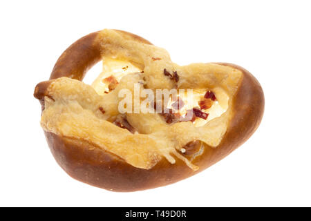 A pretzel with melted cheese and ham pieces. Stock Photo