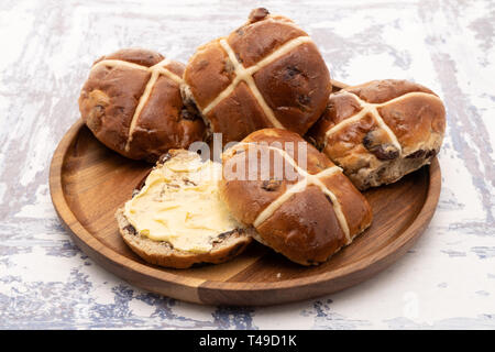 Hot cross buns on a wooden plate Stock Photo
