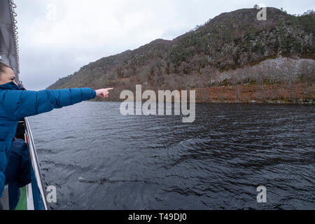 Tourist searching for monster Nessie during a cruise boat ride on Loch Ness, Scottish Highlands, Scotland, UK, Europe Stock Photo