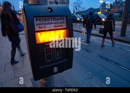 Pedestrians crossing the street despite red lights and orders to wait, Edinburgh, Scotland, UK, Europe Stock Photo