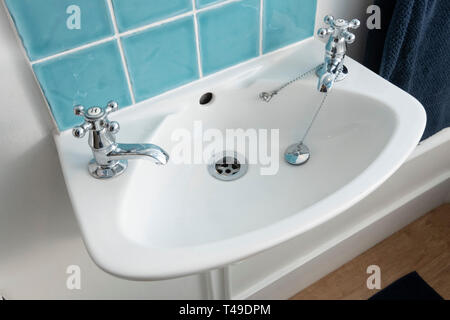 Bathroom sink with hot and cold faucets Stock Photo