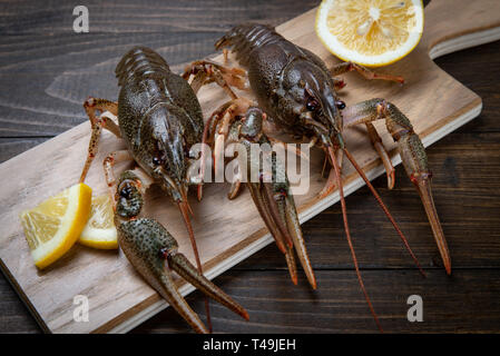 Crayfish. Red boiled crawfishes on table in rustic style, closeup. Lobster closeup. Stock Photo