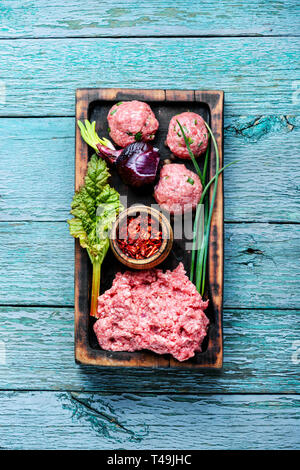 Fresh raw minced beef on cutting board and ingredients.Mince. Stock Photo