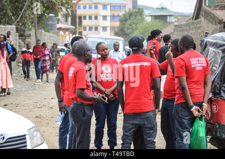 A group of activists allied to  Kenya’s Red Vests Movement are seen discussing after a church service. Activists allied to Kenya’s Red Vests Movement were protesting silently about increased levels of corruption in the government, the activists are demanding action to be taken against all government officials involved in corruption. Kenya loses billions of dollars to corruption in government departments every year and very less action is taken to curb the vice. Every Sunday the activists conduct an anti-corruption protest in churches and streets in different towns of Kenya hoping that the gove Stock Photo