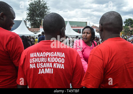 A group of activists allied to  Kenya’s Red Vests Movement are seen engaging a member of the public in the streets of Nakuru during the anti-corruption protest Activists allied to Kenya’s Red Vests Movement were protesting silently about increased levels of corruption in the government, the activists are demanding action to be taken against all government officials involved in corruption. Kenya loses billions of dollars to corruption in government departments every year and very less action is taken to curb the vice. Every Sunday the activists conduct an anti-corruption protest in churches and Stock Photo