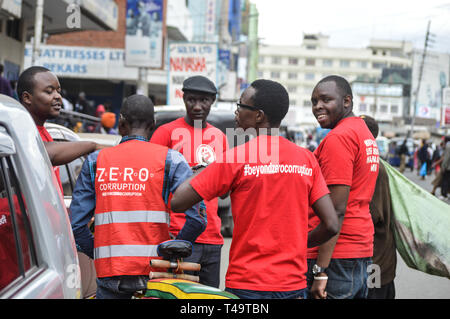 A group of activists allied to  Kenya’s Red Vests Movement are seen engaging a member of the public in the streets of Nakuru during the anti-corruption protest Activists allied to Kenya’s Red Vests Movement were protesting silently about increased levels of corruption in the government, the activists are demanding action to be taken against all government officials involved in corruption. Kenya loses billions of dollars to corruption in government departments every year and very less action is taken to curb the vice. Every Sunday the activists conduct an anti-corruption protest in churches and Stock Photo