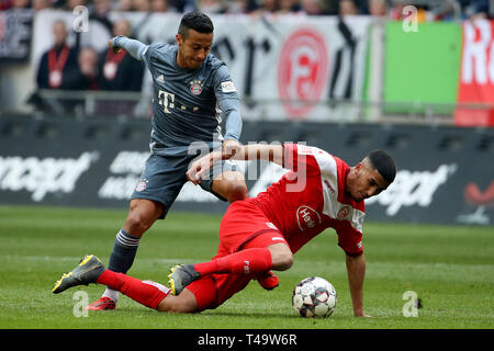 Dusseldorf, Germany. 14th Apr, 2019. Thiago Alcantara (L) of Bayern Munich vies with Aymen Barkok of Dusseldorf during the Bundesliga match between FC Bayern Munich and Fortuna Dusseldorf 1895 in Dusseldorf, Germany, April 14, 2019. Munich won 4-1. Credit: Ulrich Hufnagel/Xinhua/Alamy Live News Stock Photo