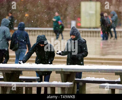 Chicago, USA. 14th Apr, 2019. Two women play with snow at the Millennium Park in Chicago, the United States, on April 14, 2019. A snowfall hit Chicago on Sunday. Credit: Wang Ping/Xinhua/Alamy Live News Stock Photo