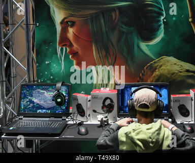 Berlin, Germany. 12th Apr, 2019. A young visitor plays a computer game with headphones on his ears at the Gamefest in the Kulturbrauerei as part of Gamesweekberlin 2019. The international network meeting of the games industry will take place from 08.04. to 14.04.2019. Credit: Jens Kalaene/dpa-Zentralbild/dpa/Alamy Live News Stock Photo