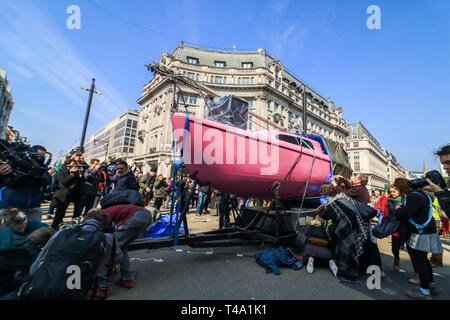 London, UK. 15th Apr, 2015. Environment activists from Extinction Rebellion unfurl a large pink sailing boat blocking Oxford Circus to highlight the threat of global warming on the planet and ecosystem and to urge the government to take action Credit: amer ghazzal/Alamy Live News Stock Photo