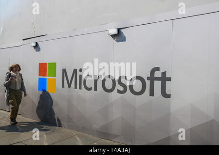 London, UK. 15th Apr, 2019. Pedestrians walk past a wall with the logo Microsoft Software giant as a new store prepares to open Oxford Street Credit: amer ghazzal/Alamy Live News Stock Photo