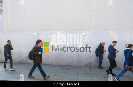 London, UK. 15th Apr, 2019. Pedestrians walk past a wall with the logo Microsoft Software giant as a new store prepares to open Oxford Street Credit: amer ghazzal/Alamy Live News Stock Photo