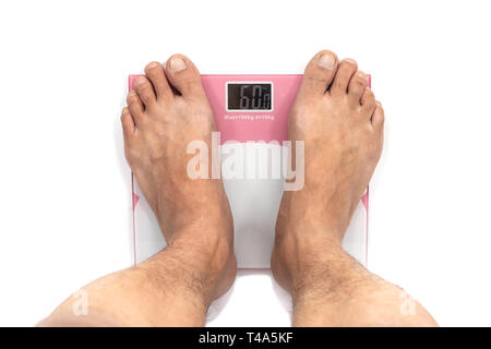 Man Standing on digital weighing apparatus. Feet on digital weight scale isolated on white background Stock Photo