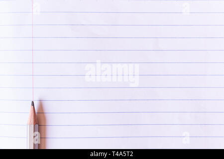 Top view gray pencil on lined paper with copy space background and texture. Stock Photo