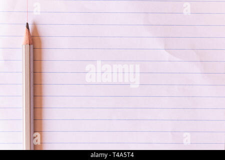 Top view gray pencil on lined paper with copy space background and texture. Stock Photo