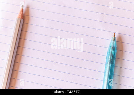 Top view pen and pencil on lined paper with copy space background. Stock Photo