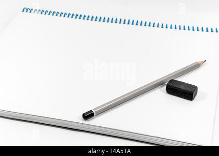 Top view close up gray pencil and rubber put on notebook with copy space. Stock Photo