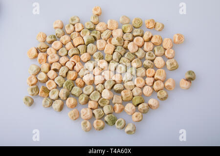 Dry green peas on a white background. Gardening and agriculture. Selected seeds for planting in the agricultural field Stock Photo