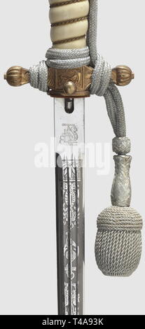A model 1938 dagger for naval officers, with portepee and hanger, Maker Eickhorn, Solingen Nickel-plated blade with an etched, fouled anchor amid tendrils on both sides as well as a maker's mark on the ricasso. Crossguard and pommel with mostly preserved gilding. White plastic grip with wire winding. Push-button scabbard release. The gilt scabbard decorated with 'thunder-bolt' pattern (spotted). Length 38.5 cm. Silver portepee. The hanger of black ribbed silk with black velvet lining and silver-plated aluminium fittings for administrative officials. In beautiful condition, , Editorial-Use-Only Stock Photo