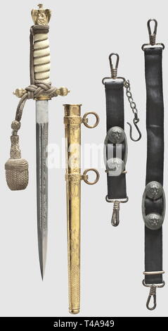 A model 1938 dagger for naval officers, with portepee and hangers, Maker F.W. Höller, Solingen The blade (light spotting) with etched fouled anchor and sailing ship, respectively amid tendrils and maker's mark on the ricasso. Crossguard and pommel retaining a good amount of gilding. White plastic grip with wire winding and scabbard release button. Gilt 'lightning bolt' scabbard (some spotting). Silver portepee with signs of wear and black ribbed silk hangers with black velvet backing. Formerly silver-plated administrative officers type iron fittings. Length 38 cm, historic,, Editorial-Use-Only Stock Photo