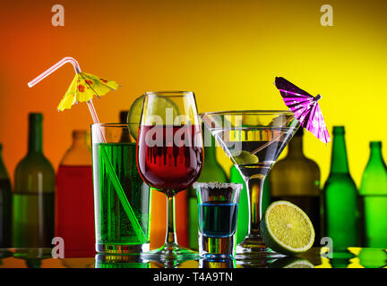 Different alcohol drinks and cocktails on bar Stock Photo