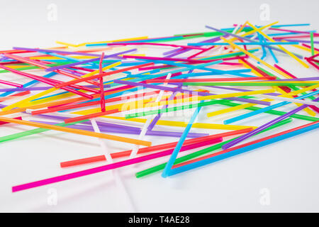 Colorful and toxic straws lying on the white surface Stock Photo
