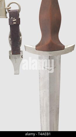 A model 1933 SA service dagger with leather hanger, Maker Jos. Schlimbach, Solingen The blade with etched motto and maker's mark. Nickel silver grip fittings, the crossguard punched 'Om' for SA Group Ostmark. Brown wooden grip (small dent) with inset nickel silver eagle and enamelled SA emblem. Burnished, and in the time of wear brown over-painted, steel scabbard (some scratches) with nickel silver fittings. Brown leather hanger, the clip with Assmann logo. Length 35 cm, historic, historical, 1930s, 20th century, storm battalion, stormtroopers, armed and uniformed branch of, Editorial-Use-Only Stock Photo