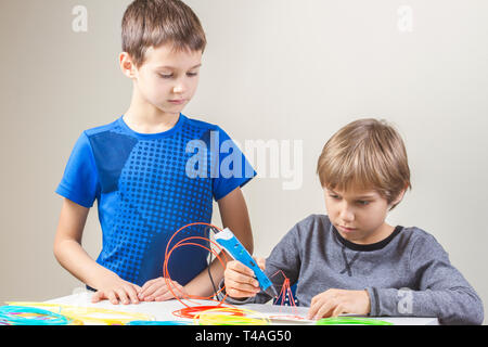 Two boys creating with 3 d printing pen Stock Photo