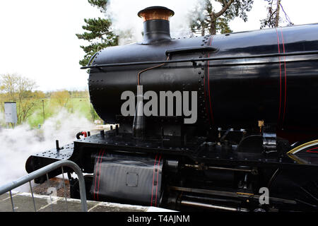 Engine No. 7820 - Steam rises from the locomotive, Dinmore Manor,(built 1950), as it waits at signal in Broadway station for the journey to Cheltenham Stock Photo