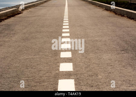 highway with a dividing strip goes into the distance Stock Photo