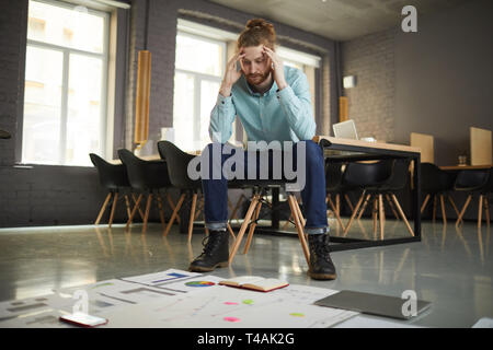 Puzzled Businessman Looking at Documents Stock Photo