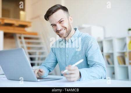 Smiling Man Using Laptop Stock Photo
