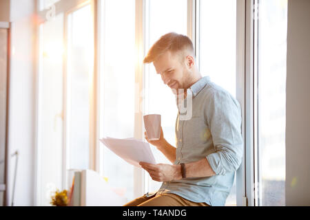 Businessman Sitting by Window Stock Photo