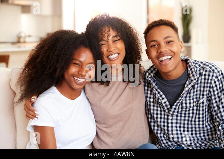 Black teen and young adult brother and sisters smiling to camera, close up Stock Photo