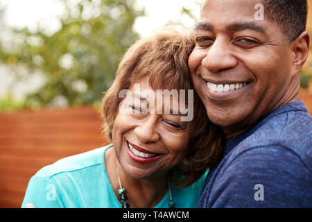 Happy senior black woman and her middle aged son embracing, head and shoulders, close up Stock Photo