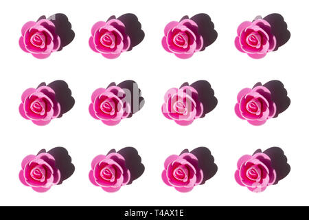 Artificial pink roses isolated on white background. Flat-lay, overview, holiday, Valentines Day concept Stock Photo