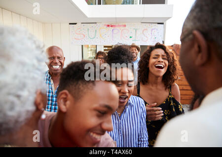 Close up of black family welcoming grandparents home for a surprise party Stock Photo