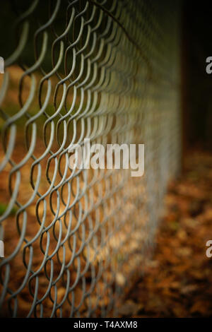 Wire chain link fence with shallow focus perspective. Stock Photo
