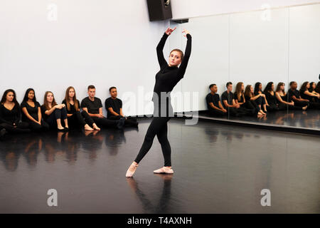 Female Ballet Student At Performing Arts School Performs For Class And Teacher In Dance Studio Stock Photo