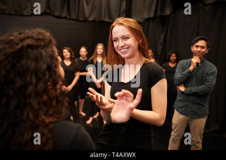 Teacher With Male And Female Drama Students At Performing Arts School In Studio Improvisation Class Stock Photo