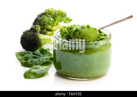Green  puree in glass jar isolated on white Stock Photo