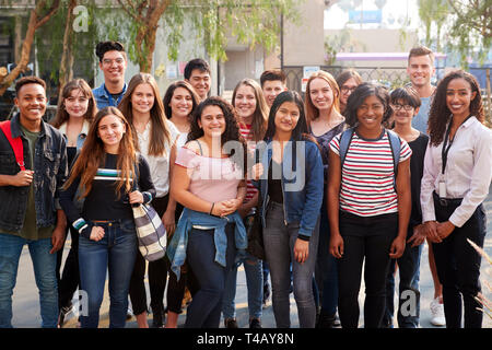 Portrait Of Smiling Male And Female College Students With Teachers Outside School Building Stock Photo