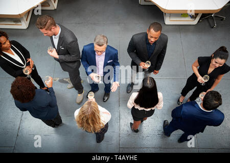 Overhead Shot Of Business Team Socializing At After Works Drinks In Modern Office Stock Photo
