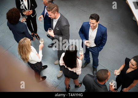 Overhead Shot Of Business Team Socializing At After Works Drinks In Modern Office Stock Photo
