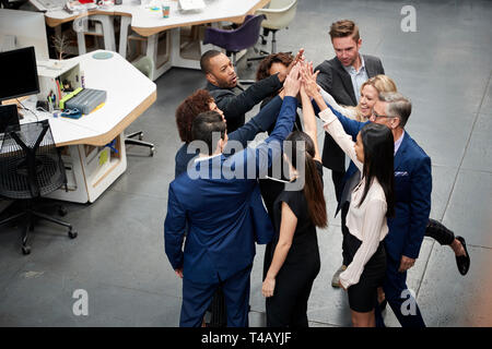 Overhead Shot Of Business Team Celebrating Success With Champagne Toast In Modern Office Stock Photo