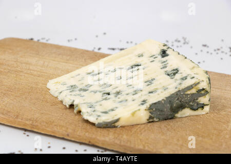 Closeup on a slice of roquefort on a wooden tray Stock Photo